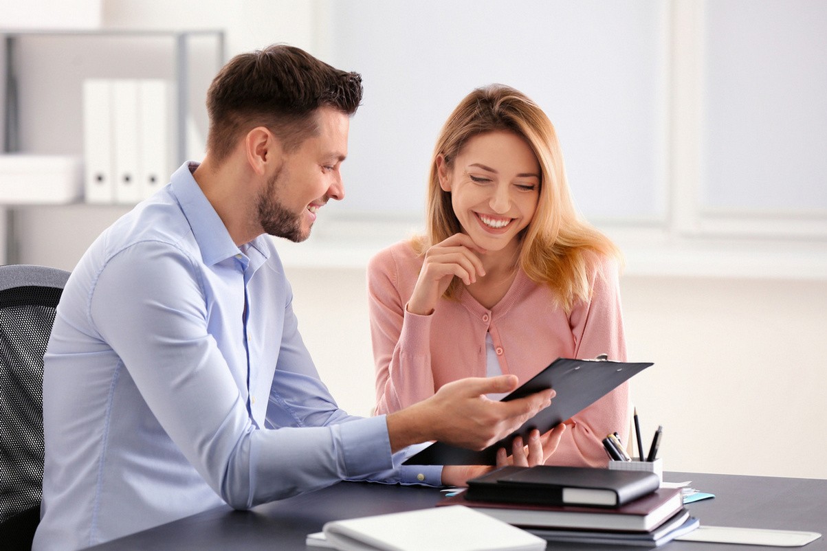 Businessman consulting young woman in office